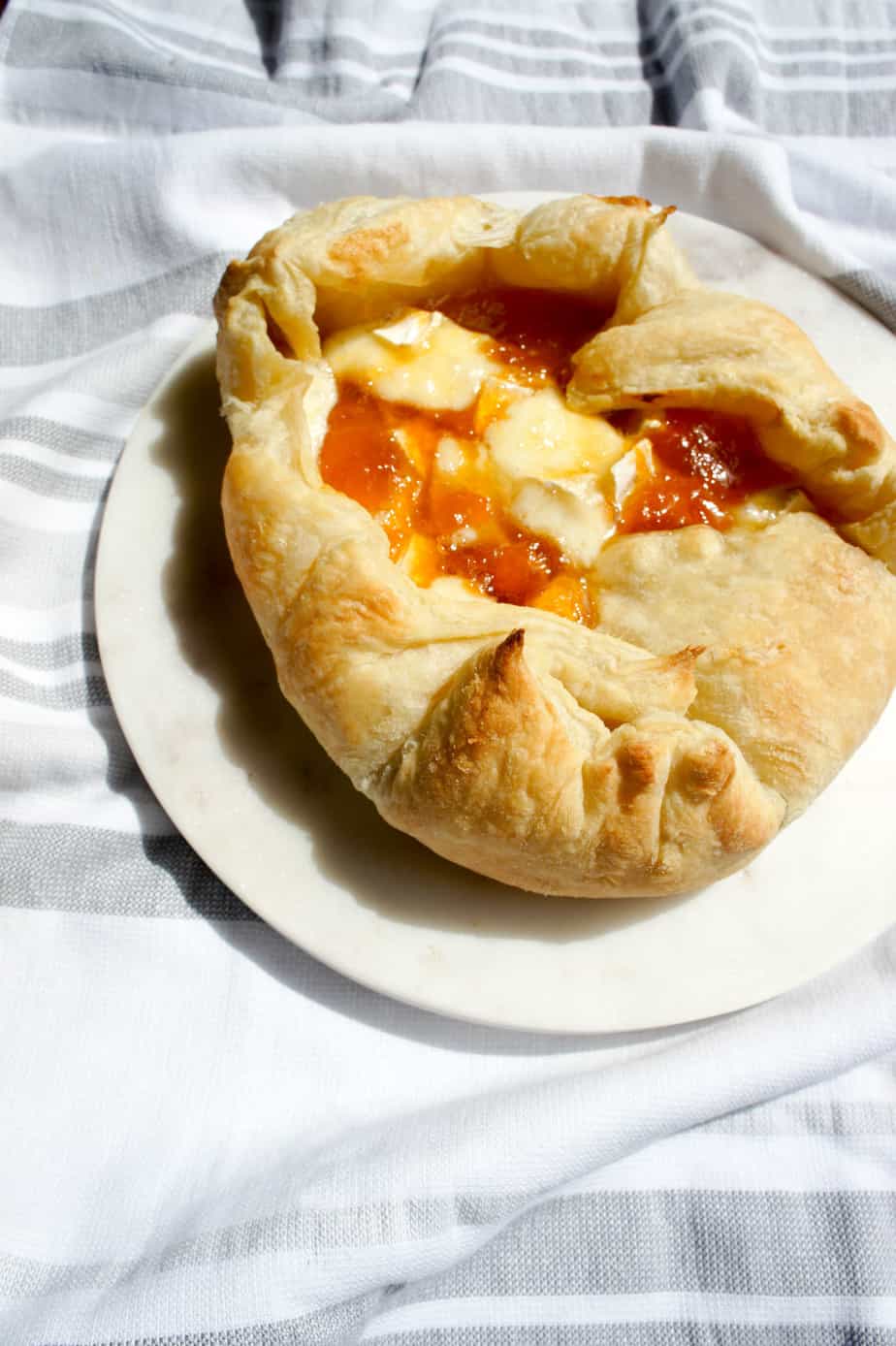 Baked Brie and Apricot Jam can easily be made in a puff pastry for a crowd, or a small ramekin for a few. Easy, delicious game food.