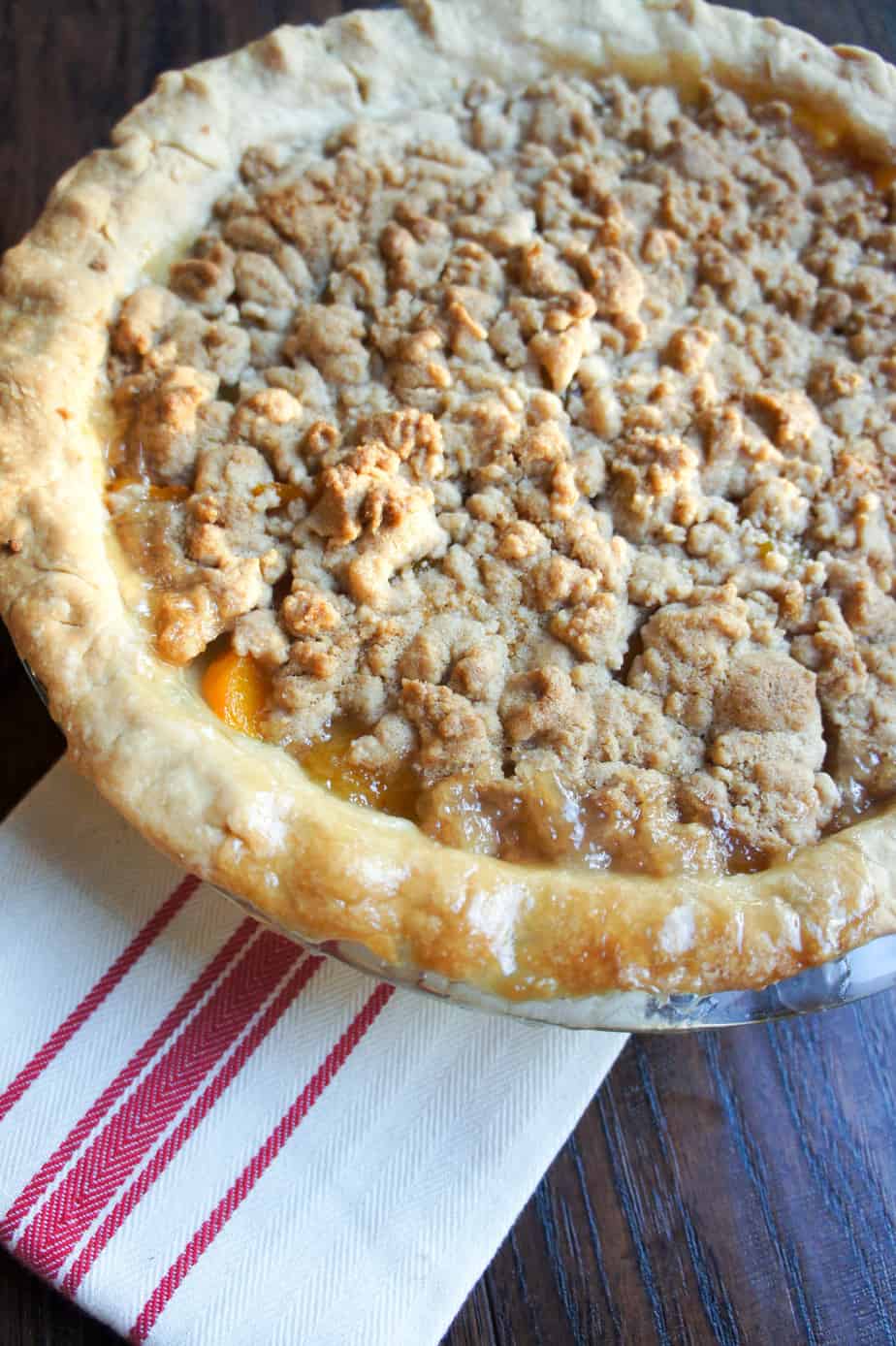 Peach Crumble Pie. The perfect cross between summer and fall. Serving with a big scoop of vanilla ice cream!