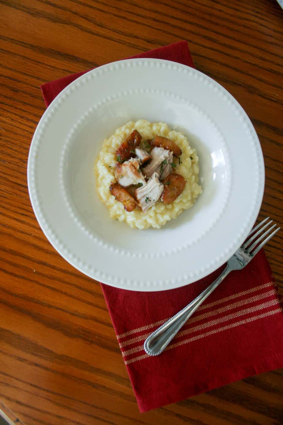 Parmesan Garlic Risotto topped with pork chunks and sweet plantains is the perfect dinner with a Hispanic twist!