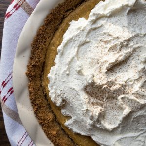 Three delicious layers in this pie: graham cracker crust, cheesecake and pumpkin pie. The perfect Thanksgiving Pumpkin Cheesecake Pie and holiday themed dessert!