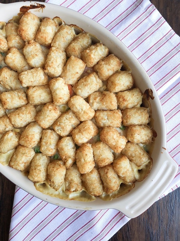 Tater Tot Chicken Pot Pie Hot Dish. The perfect Fall meal that is warm, comforting, delicious and full of hearty veggies and chicken!