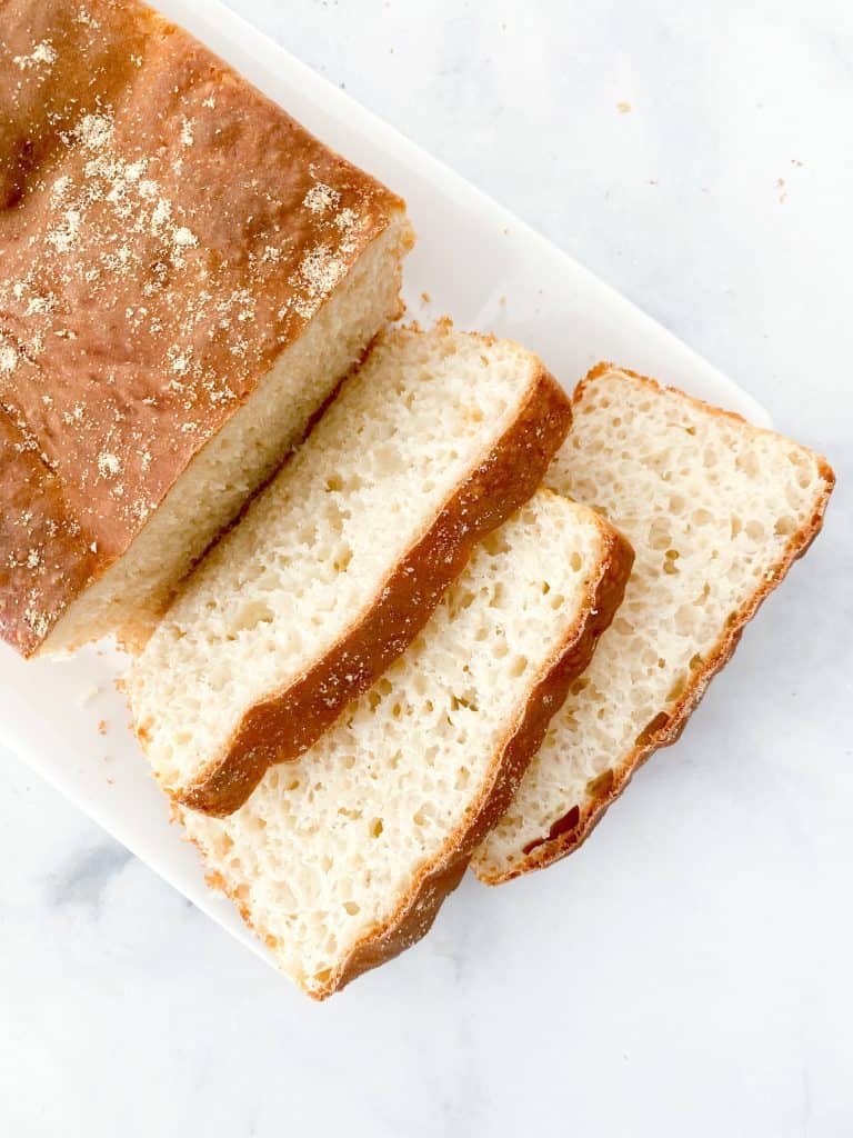 Slices of english muffin loaf with nooks and crannies on a plate