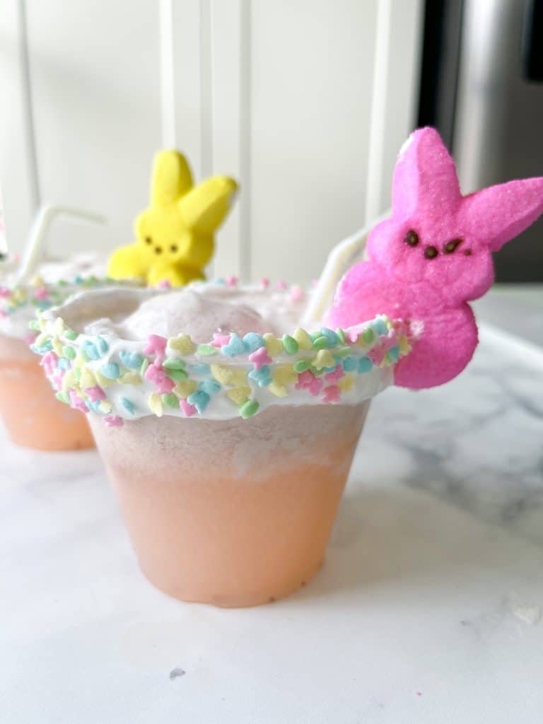 strawberry lemonade punch cups with peeps decor and a whipped cream rim