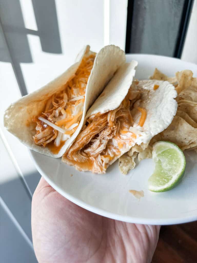 2 tacos with lime wedge and chips. 2 Ingredient Taco Chicken