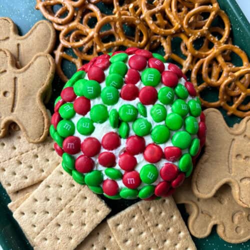 close up view of a dessert dip with M&M'S, graham crackers, pretzels and gingerbread men.