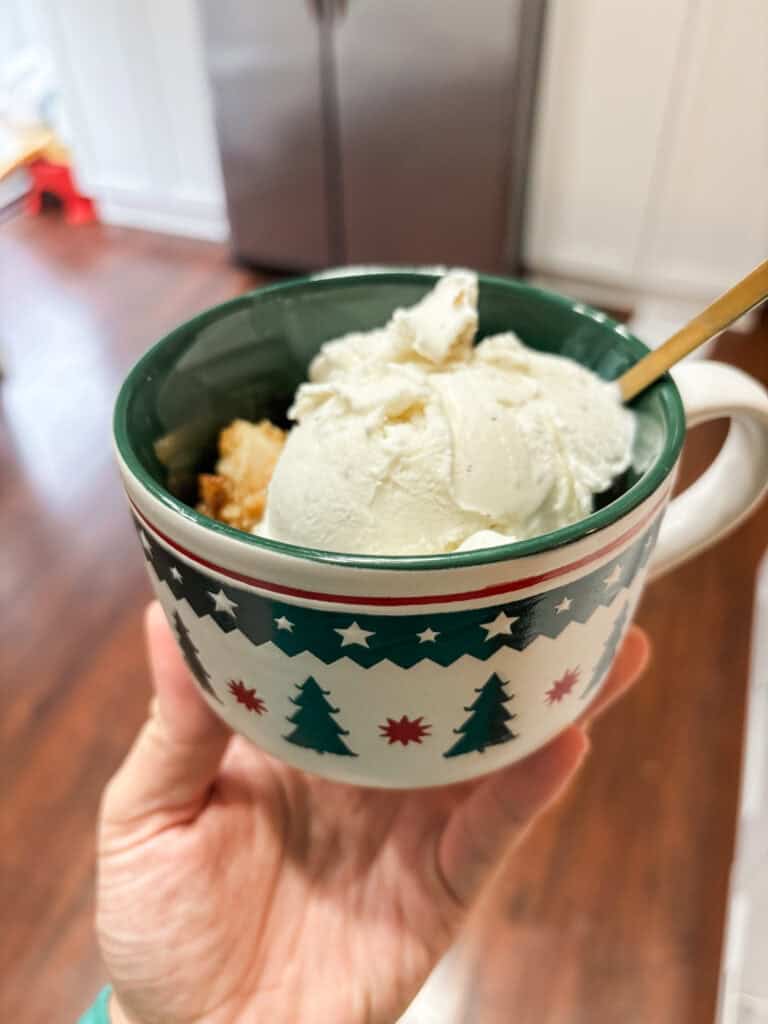 Christmas mug with cookie butter apple crumble and ice cream on top